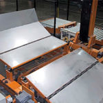 Turning device on transfer car with roller covers for paper rolls.